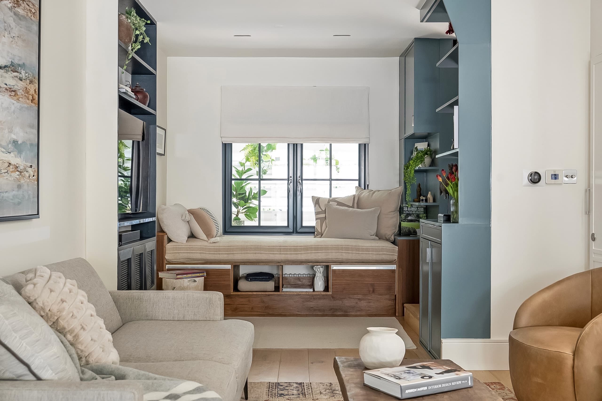 Bespoke window seat with drawer storage, set into blue-grey joinery