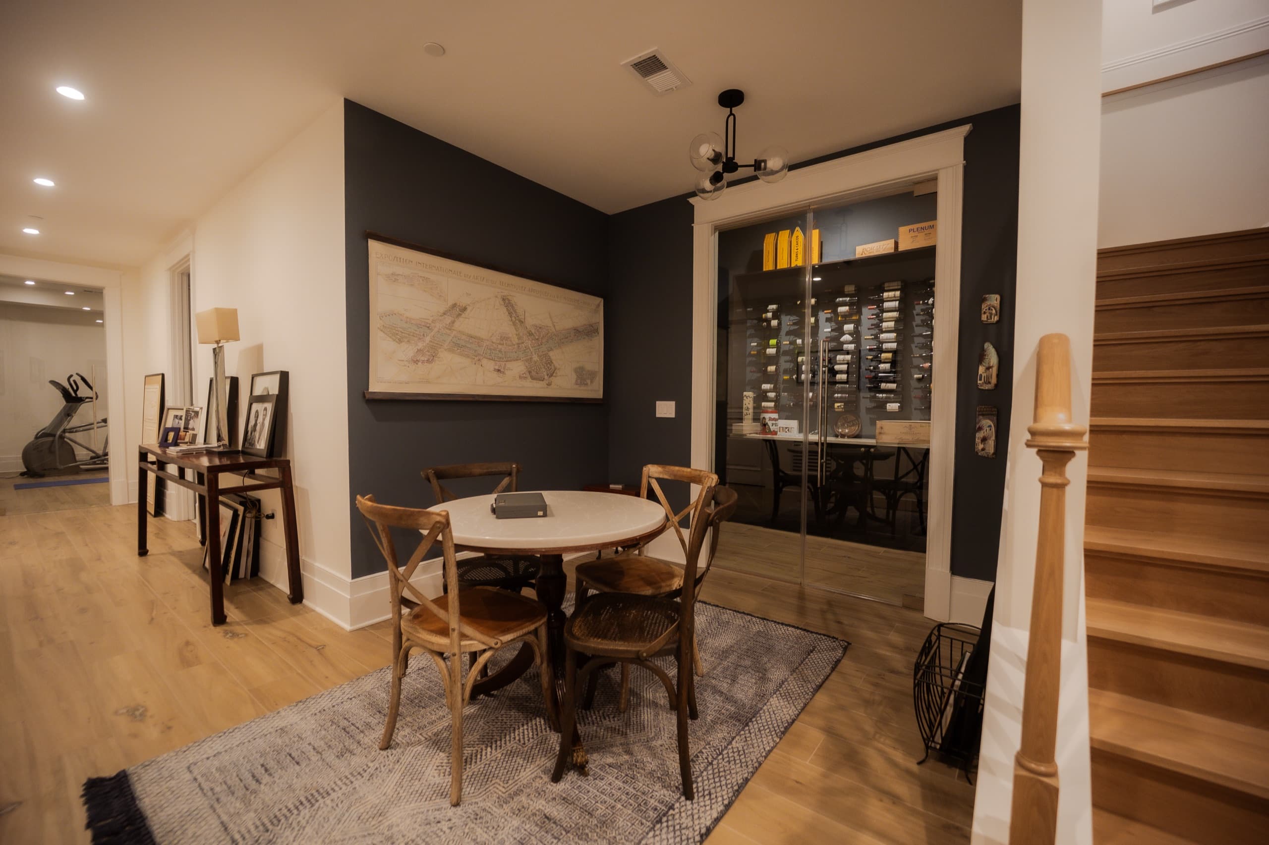 Lower-ground dining area with a glazed wine store and a charcoal feature wall