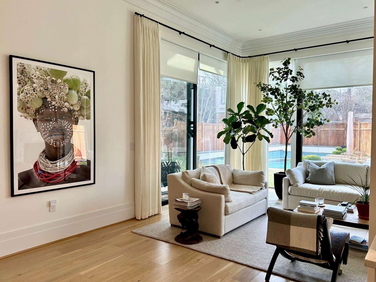 Sunlit living room with full-height garden doors, a pale sofa and a fiddle-leaf fig